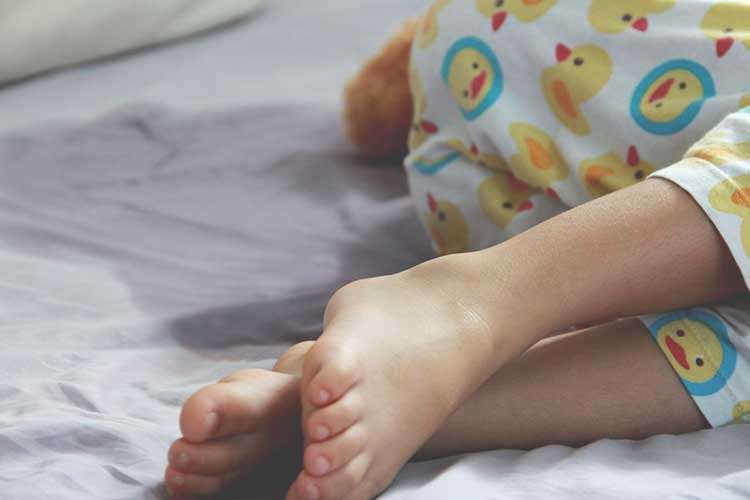 Child sleeping after wetting the bed