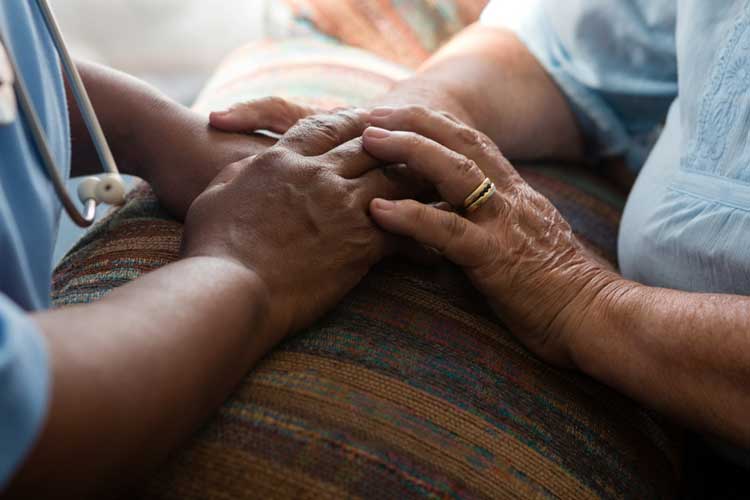 end-of-life care patient being comforted by nurse