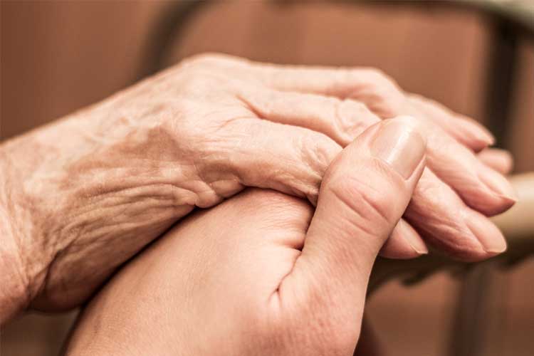 nurse hloding patient's hand