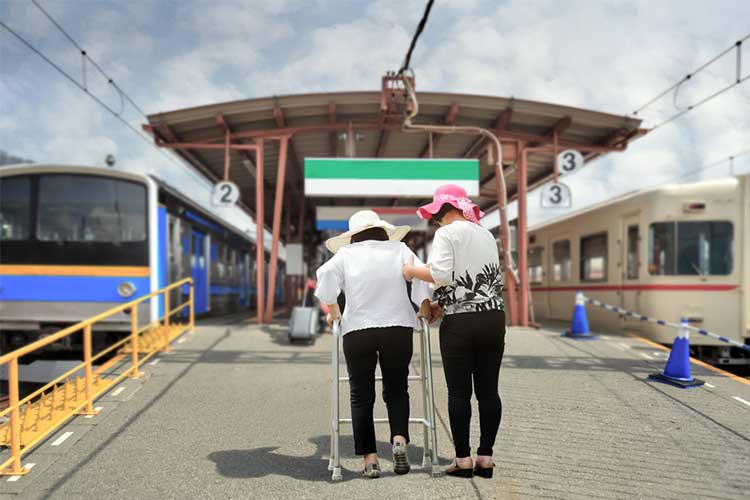 mobility issues limitations aged care two women walking one uses a mobility aid or walking frame