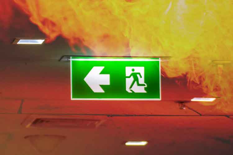Emergency sign surrounded by fire | Image