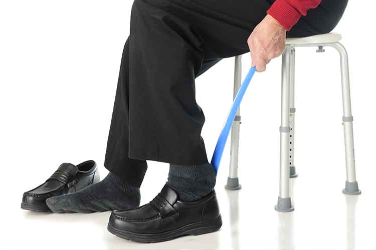 Elderly person putting on shoes | Image