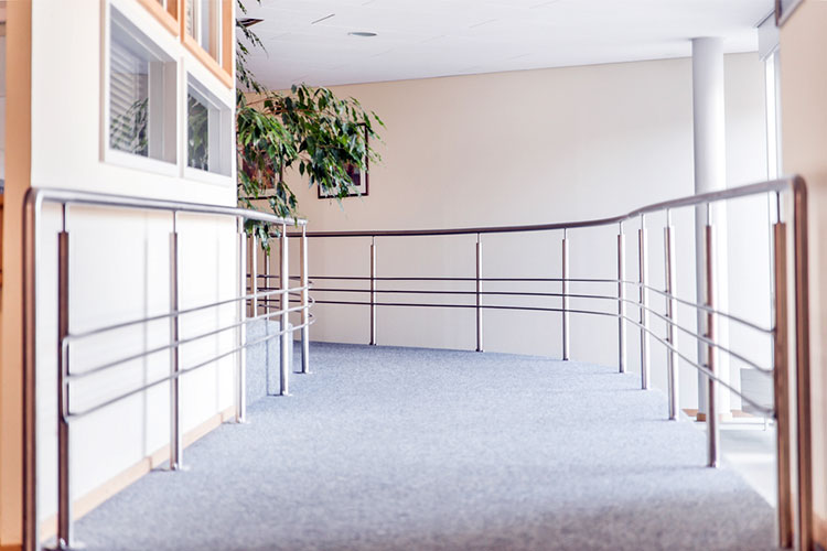 aged care facility hallway with rails for mobility assistance