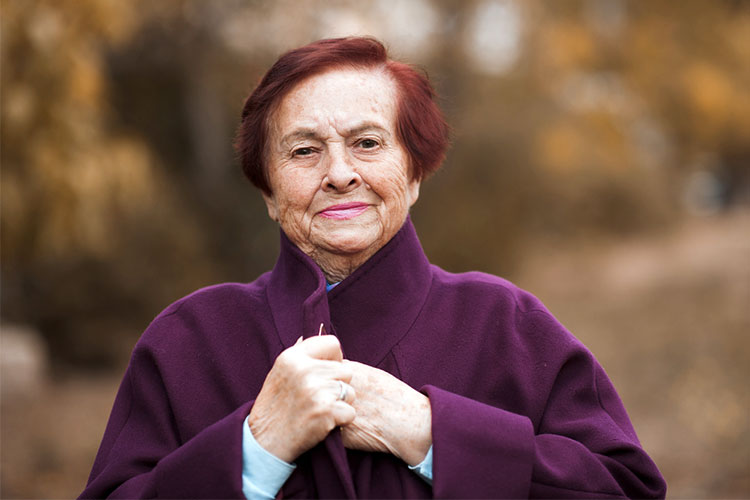 old woman wearing coat takes pride in her appearance