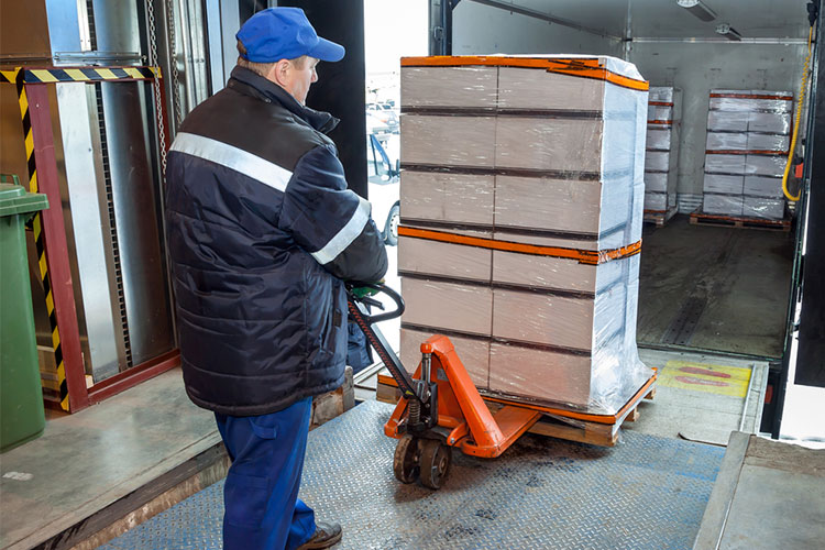 safe manual handling man using assistive lifting device