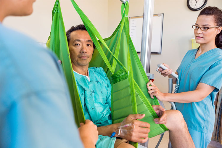 safe manual handling man using assistive lifting device