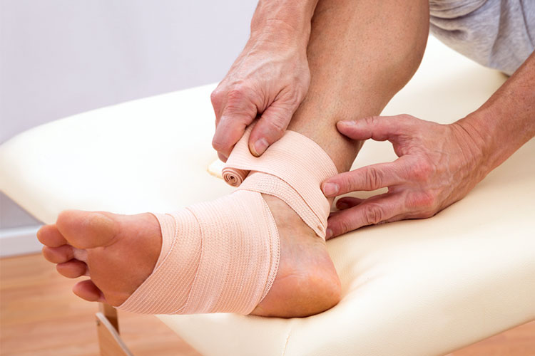 Person putting a bandage on their foot