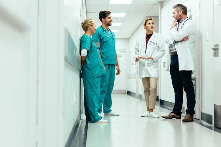 Healthcare professionals talking in hallway