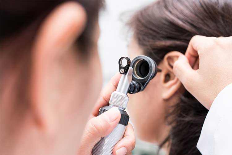 earache examination with otoscope