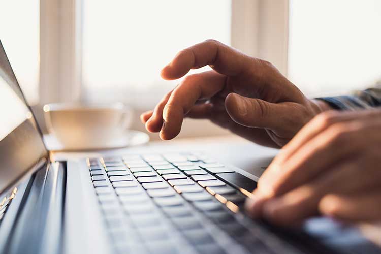 Person typing on a laptop | Image