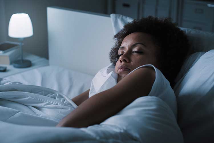 Woman sleeping in bed | Image