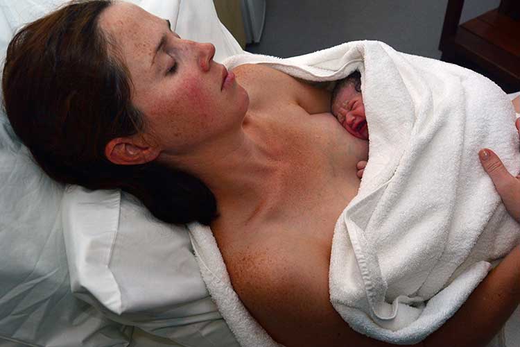 Mother with newborn baby | Image