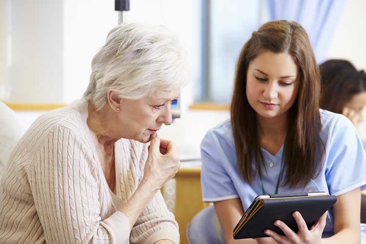 Nurse showing patient person something on a tablet