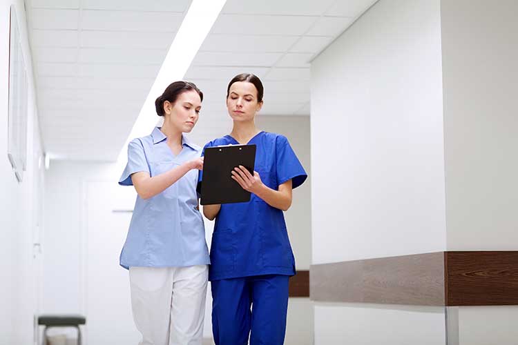 Nurse and healthcare professional sharing information | Image