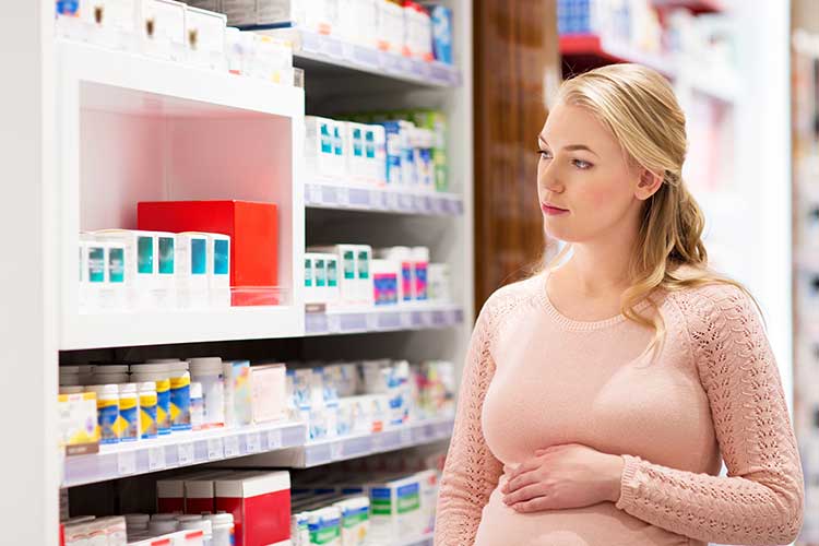 Pregnant woman at a pharmacy | Image