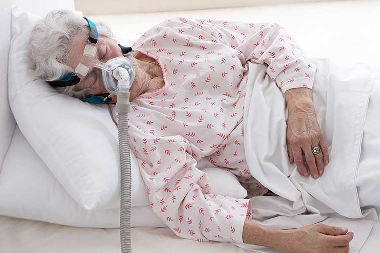 older woman sleeping while receiving niv