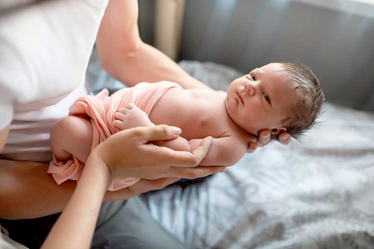 mother holding newborn baby