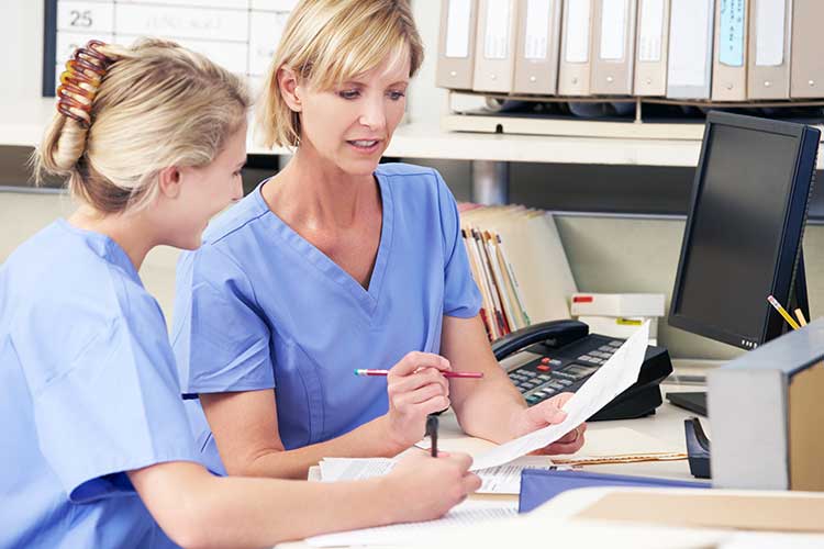 nurse talking to colleague for advice