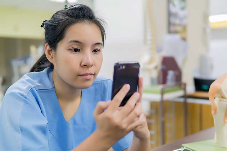 nurse checking reminder on smartphone