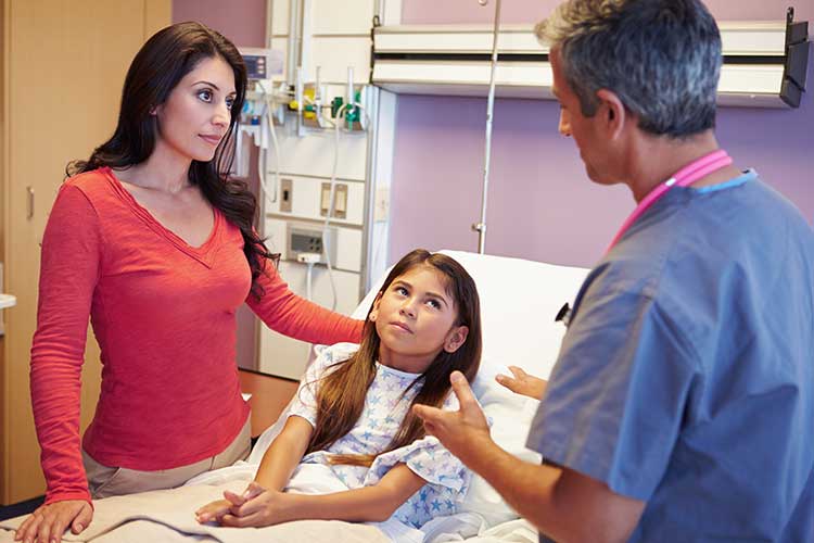 young child and mother talking to nurse about treatment options