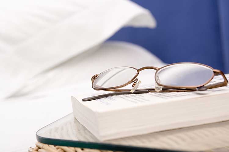 glasses on hospital bedside table