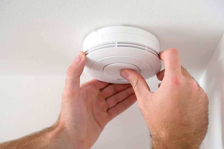 smoke alarm being checked