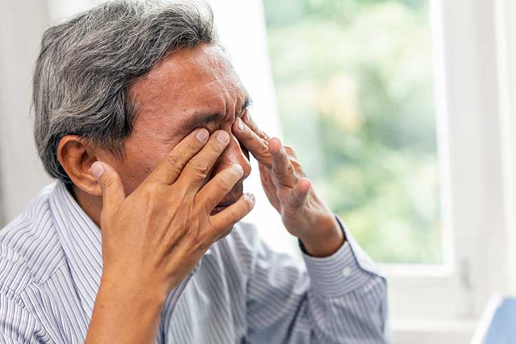 man experiencing eye strain from poor vision