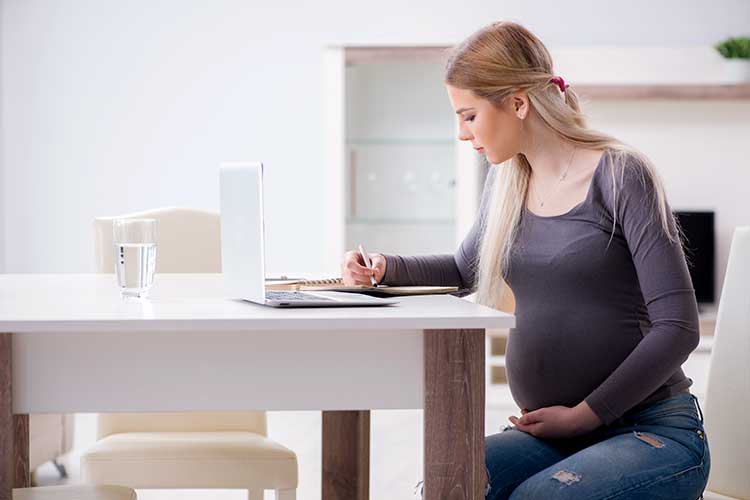 pregnant woman writing birth plan
