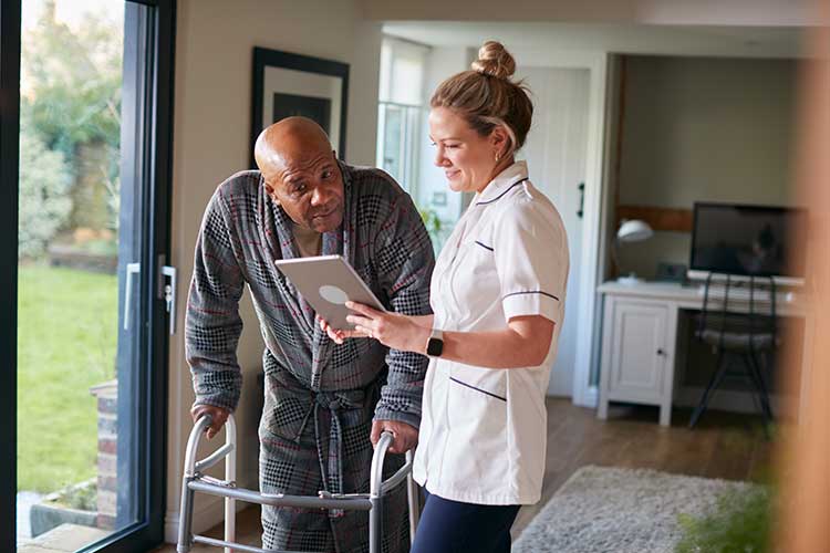 NDIS support worker assisting client with walking frame